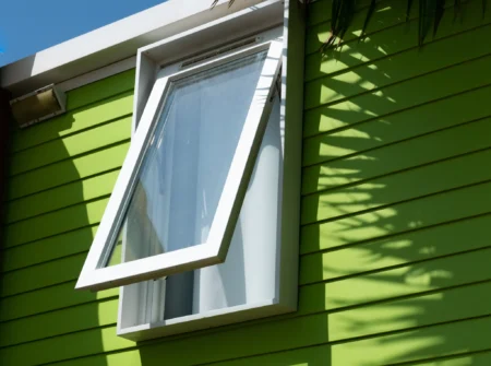 Contact Us green mobilhome window with palm
