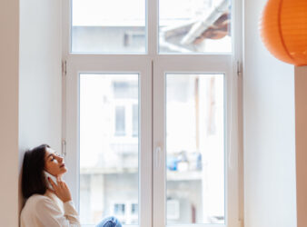 Home happy woman is talking phone whi