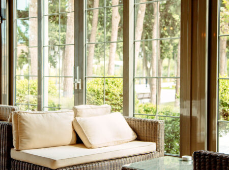 Contact Us outdoor sofa with beige cushions