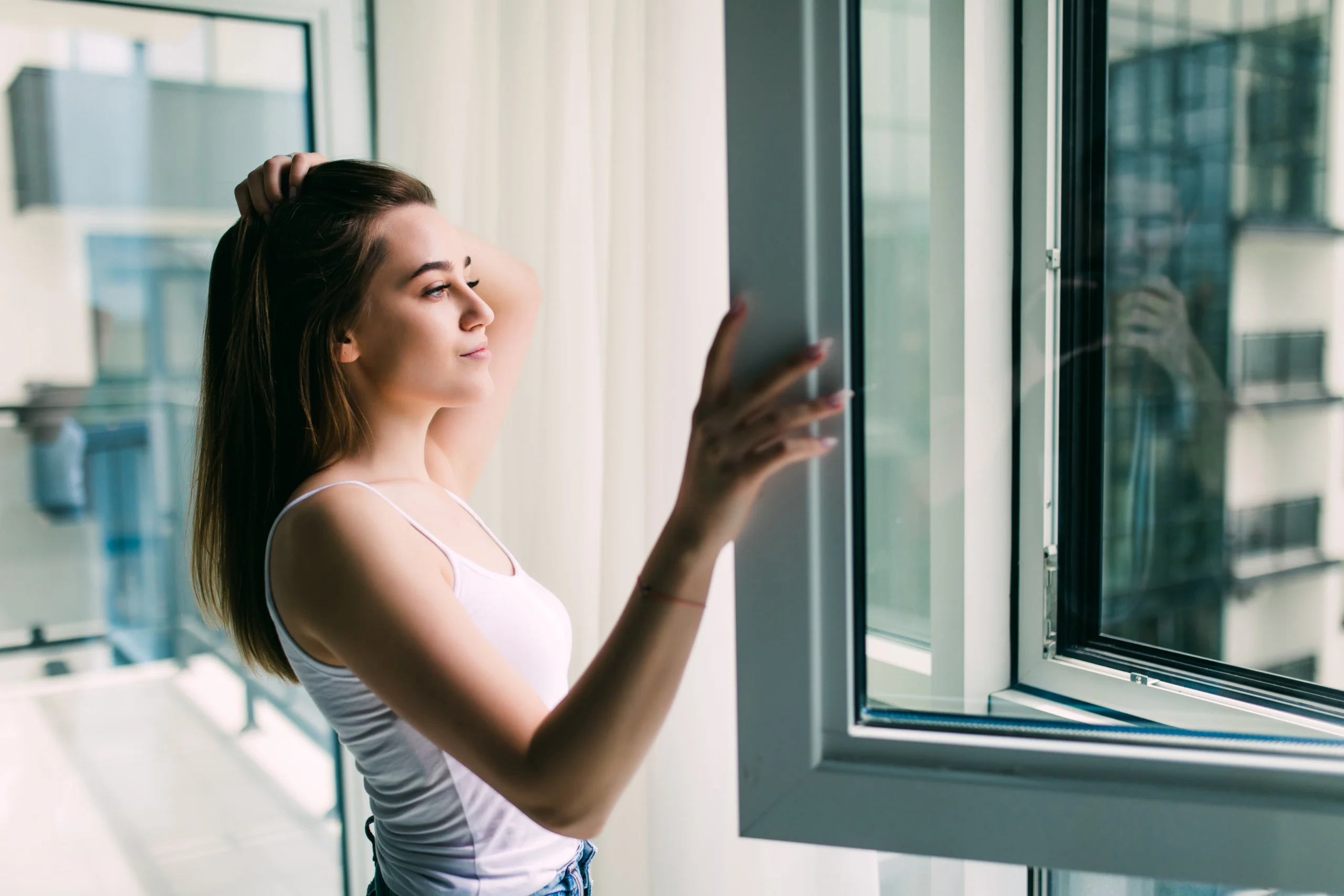 Storm Doors young woman opens plastic window
